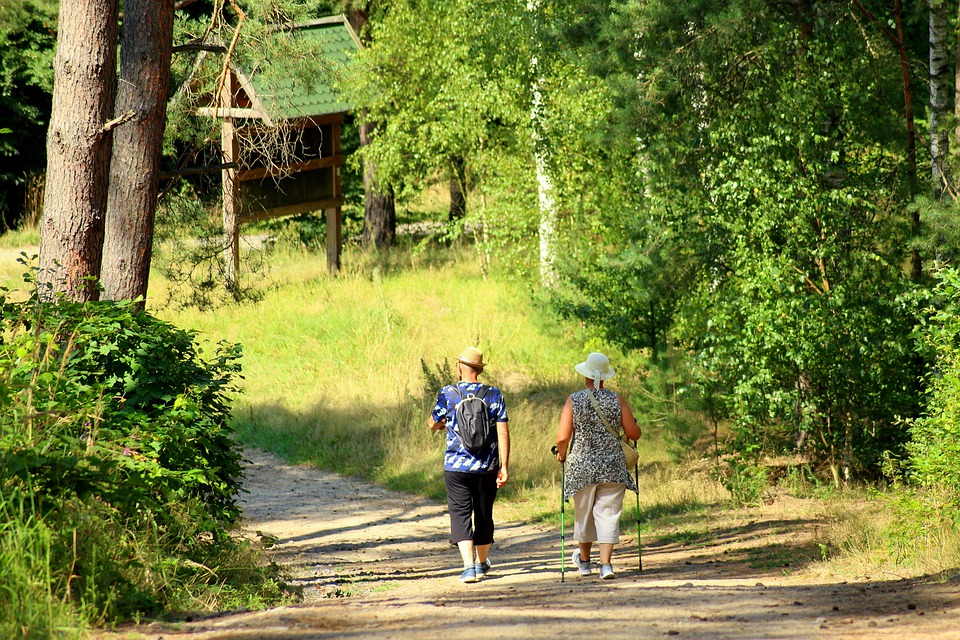 Pareja caminando por un sendero. El senderismo en la naturaleza y sus beneficios para la salud.