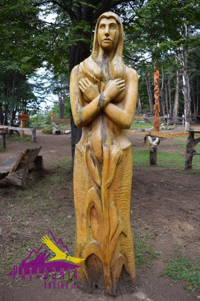 Escultura de una mujer con las manos cruzadas sobre su pecho