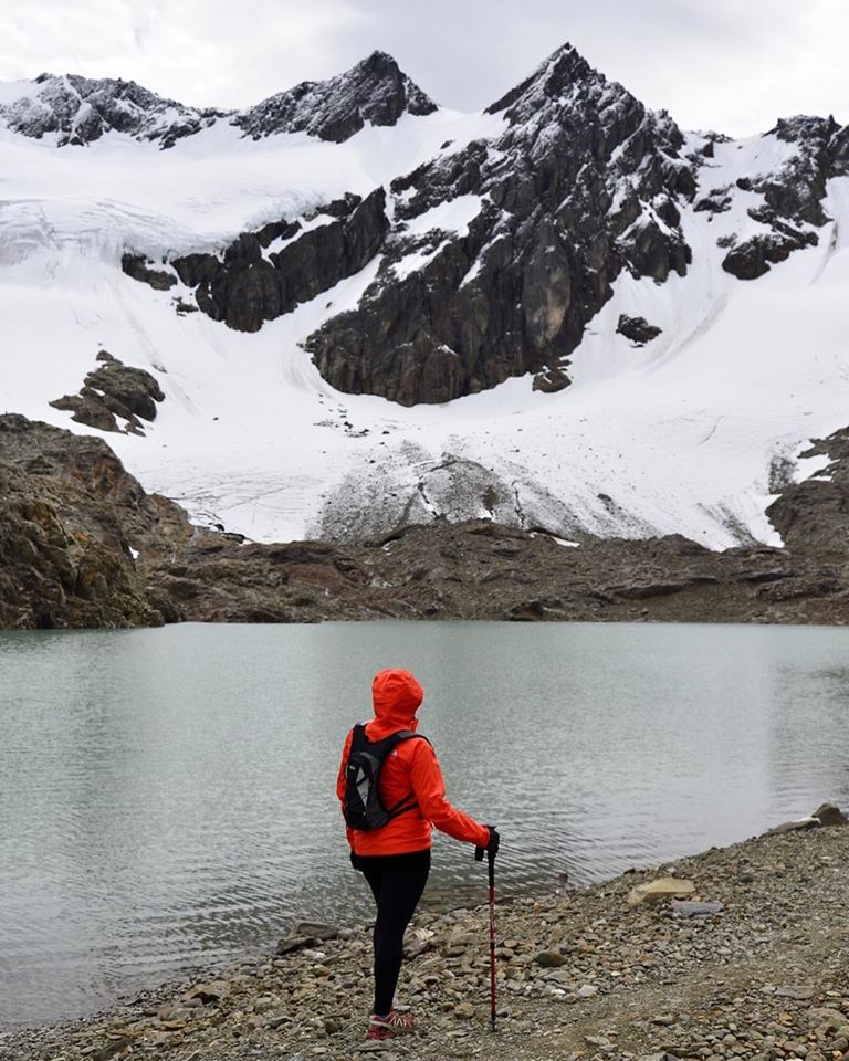 Mujer mirando a la montaña con el glaciar.