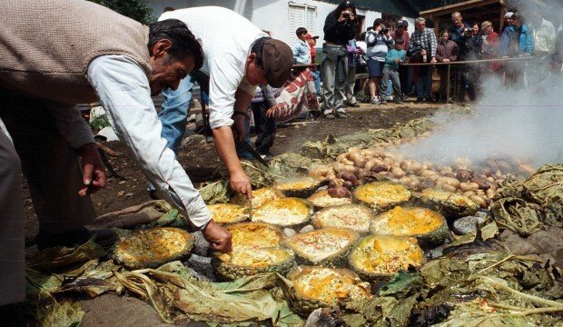 Curanto con gente preparándolo.